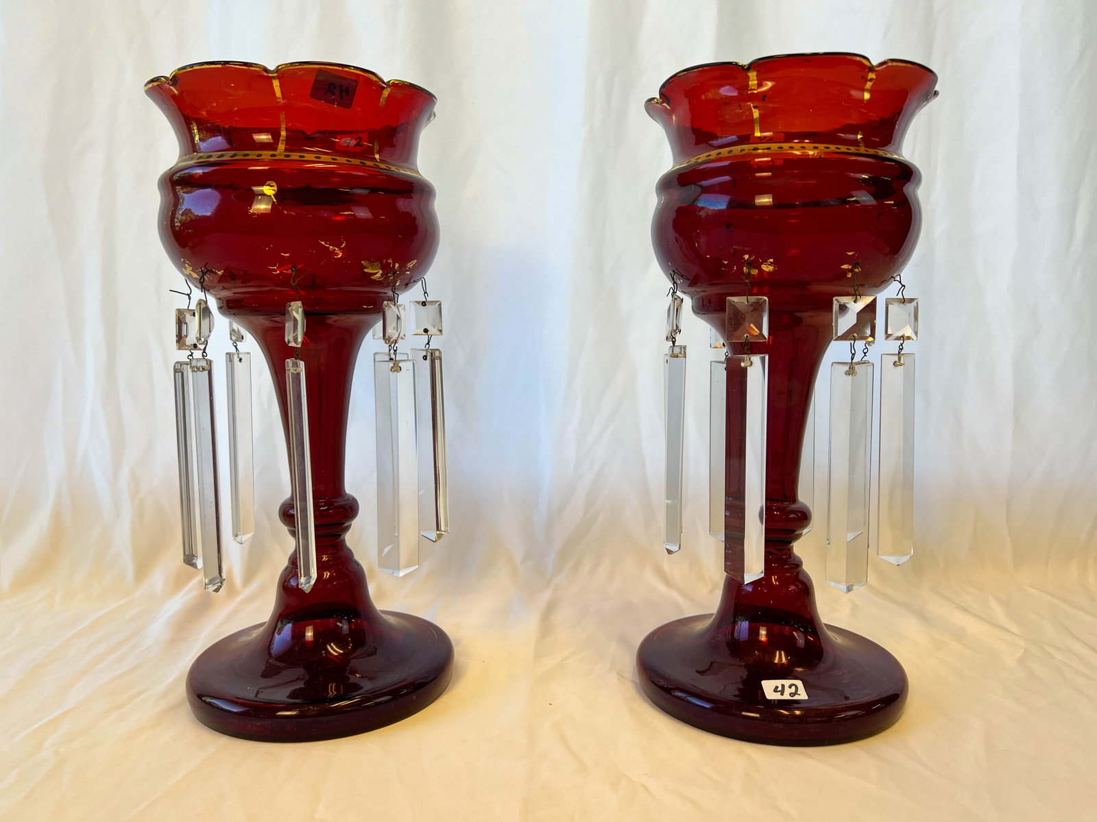Victorian Ruby Lusters: A matched pair of Victorian Lusters measures 14"Tx6 1/2"W. In excellent house ready condition. They retained their original coffin cut prisms.