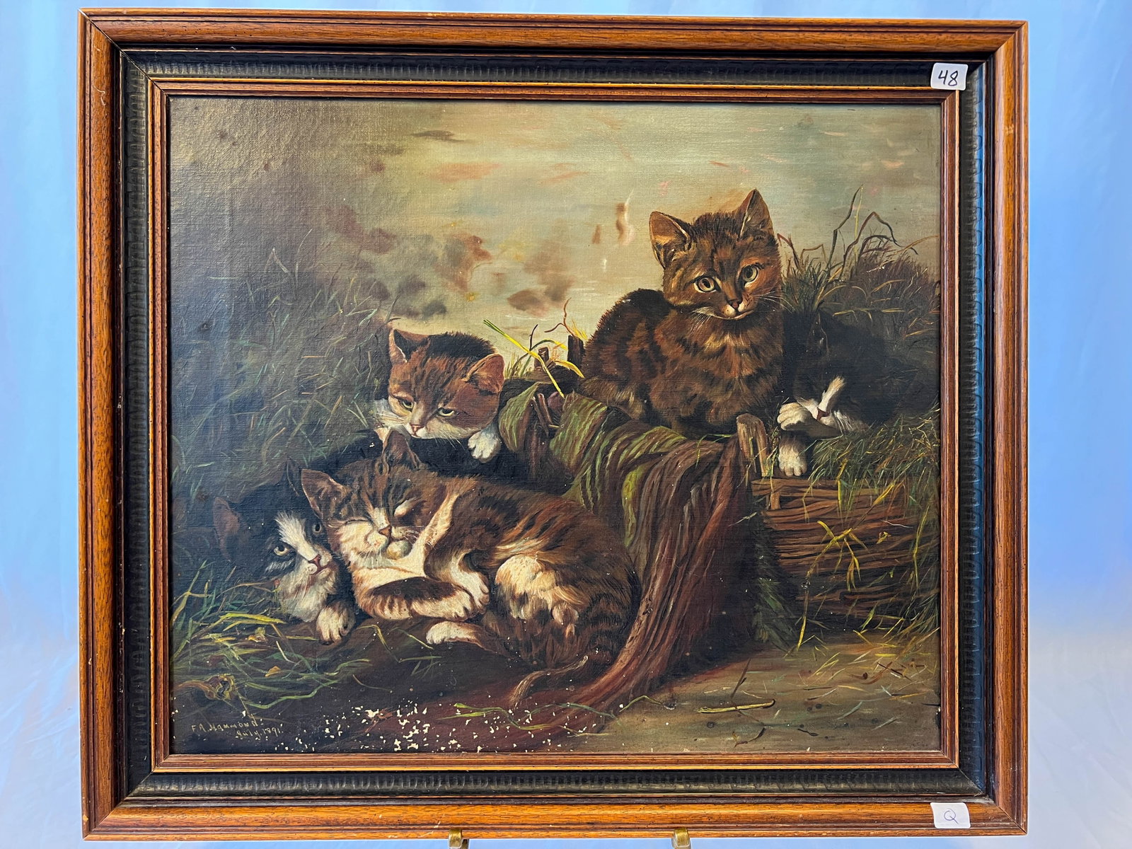 1891's F.A Hammond Oil on Canvas of Kitties: A F.A. Hammond oil on Canvas depicting five kittens and a basket. This full art oil on canvas is in excellent condition, has its original stretcher, and it has been reframed. Minor losses to bottom of