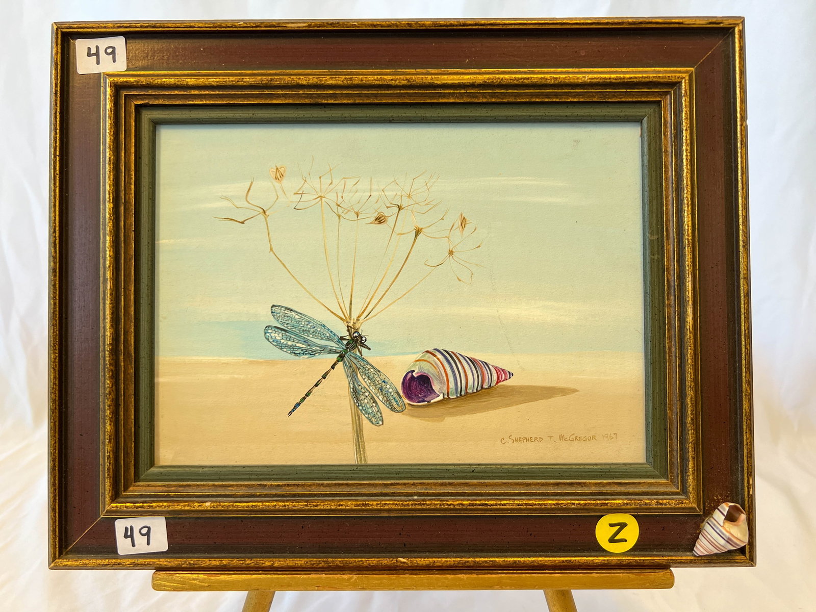 C. Shepherd T. McGregor 1967 "SUMMERTIME": A C. Shepherd T. McGregor 1967 titled "SUMMERTIME" Surreal oil on board painting of a dragon fly and sea shell on the beach. Framed it measures 9 1/2"Tx12"W. Originally from the Herman and Claudia Uih