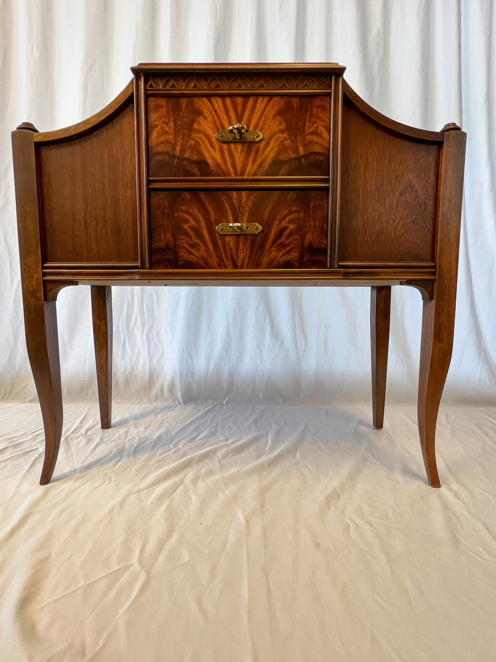 Piper smoking cabinet: A serpentine mahogany humidor cabinet. It measures 25 in by 26 in long by 10 deep.