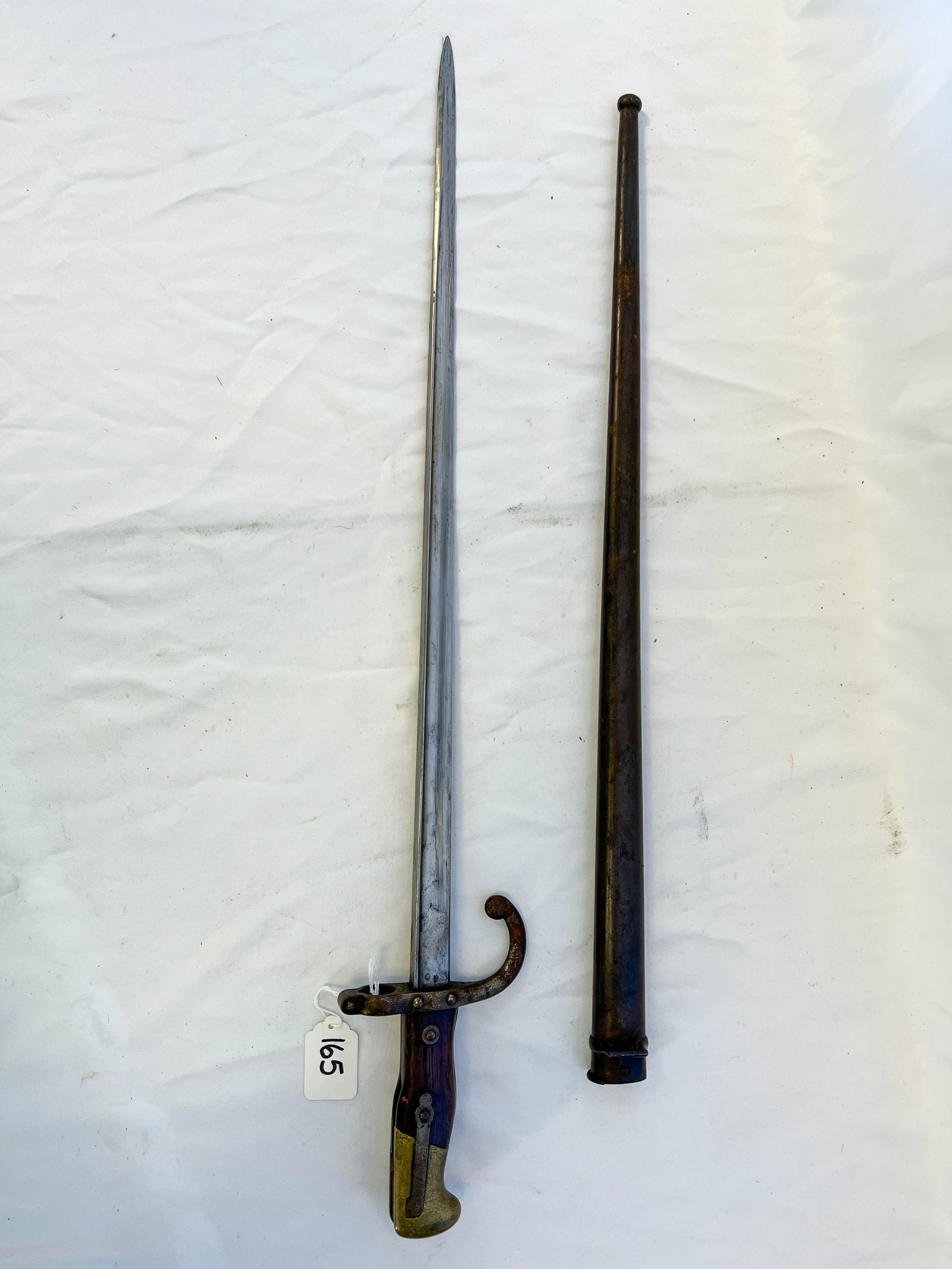 Antique French Military 1879 French Gras rifle Bayonet: An antique French military manufactured St. Etienne March of 1879 French Gras rifle Bayonet with scabbard. It measures 26in long by 4in wide.