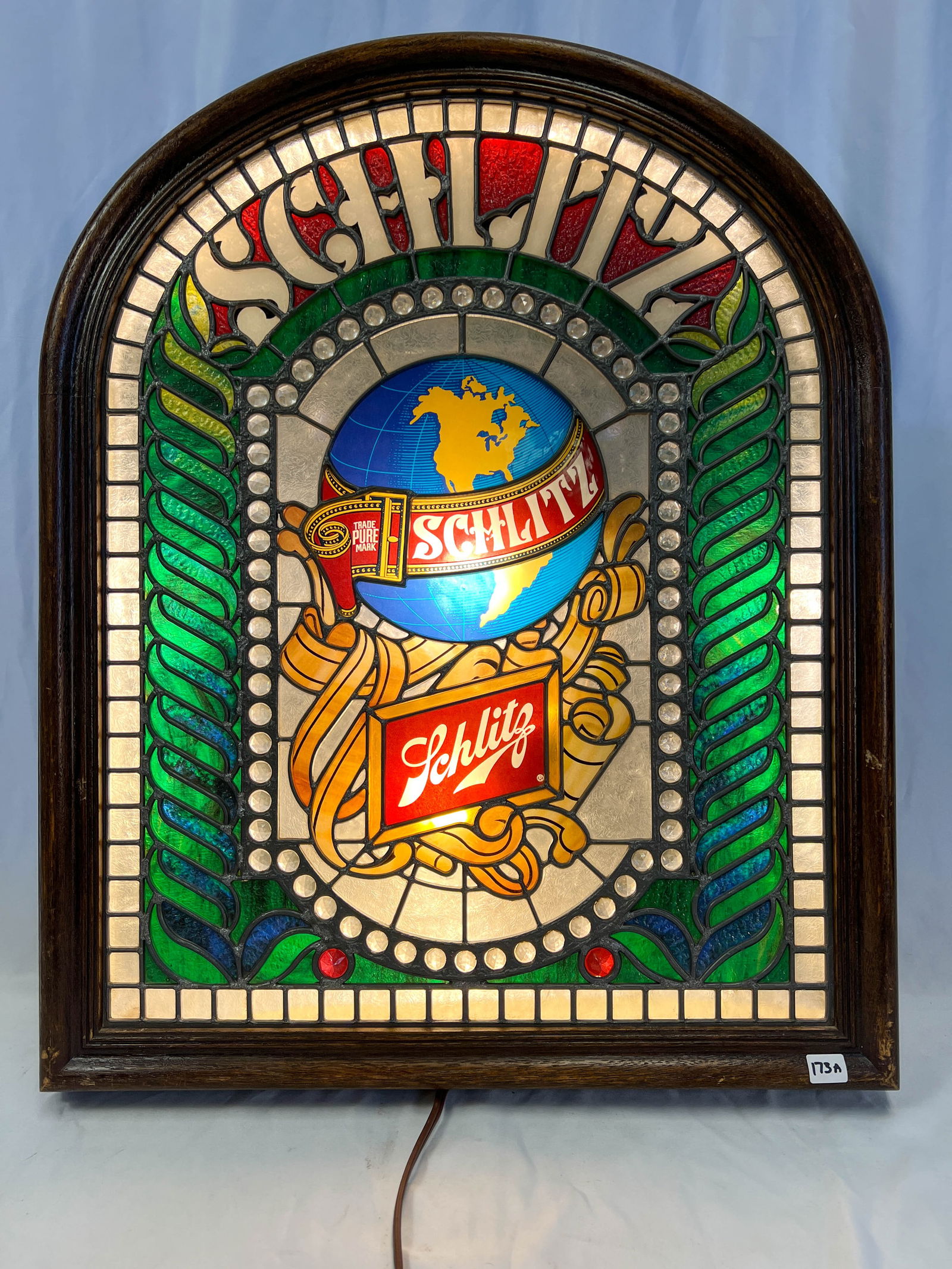 A Schlitz wall hung lighted sign in the style of a leaded glass window. (1 of 3)