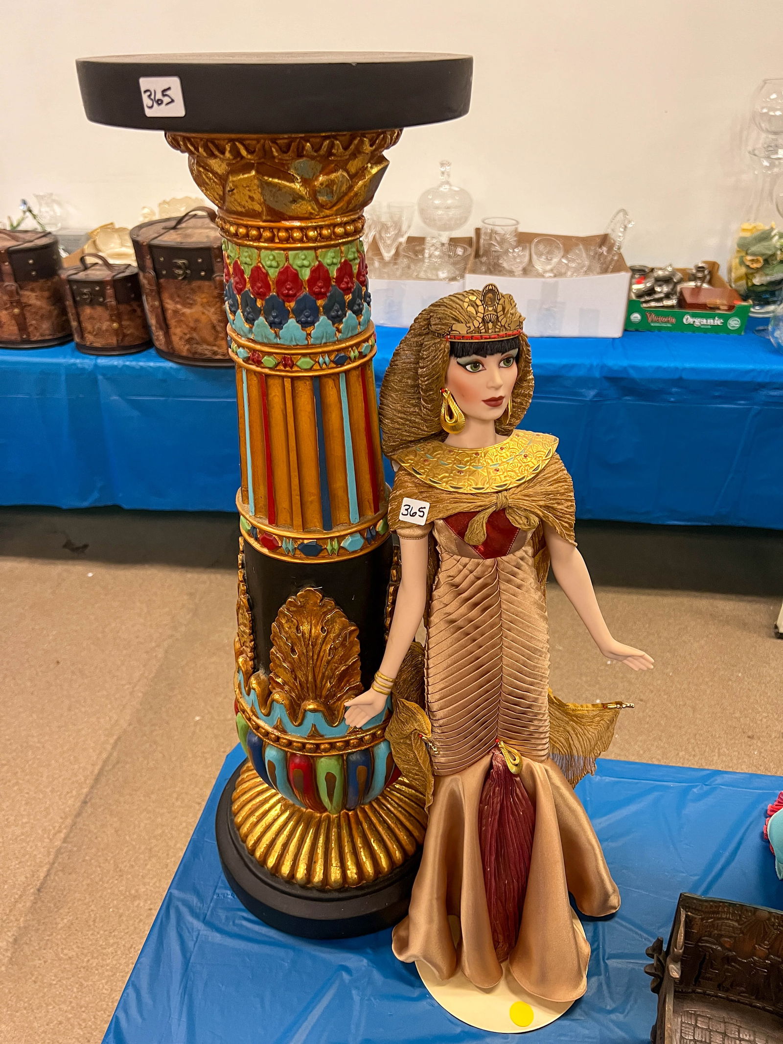 Queen Nephrites elaborately dressed doll with multi colored pillar base, doll stand. (1 of 3)