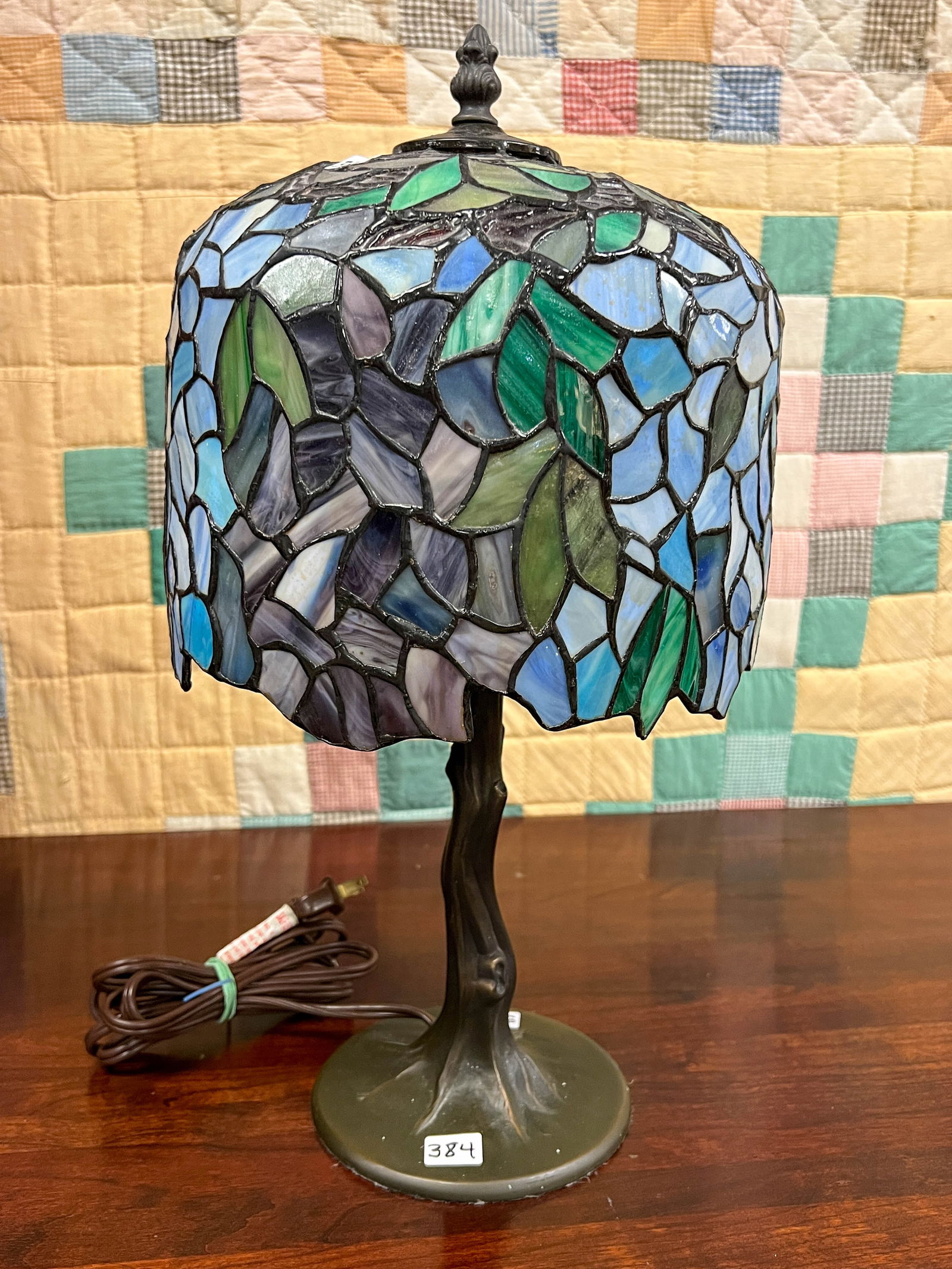 Quality leaded table lamp in red and green with tree trunk base, working condition. It measures 16"T (1 of 3)