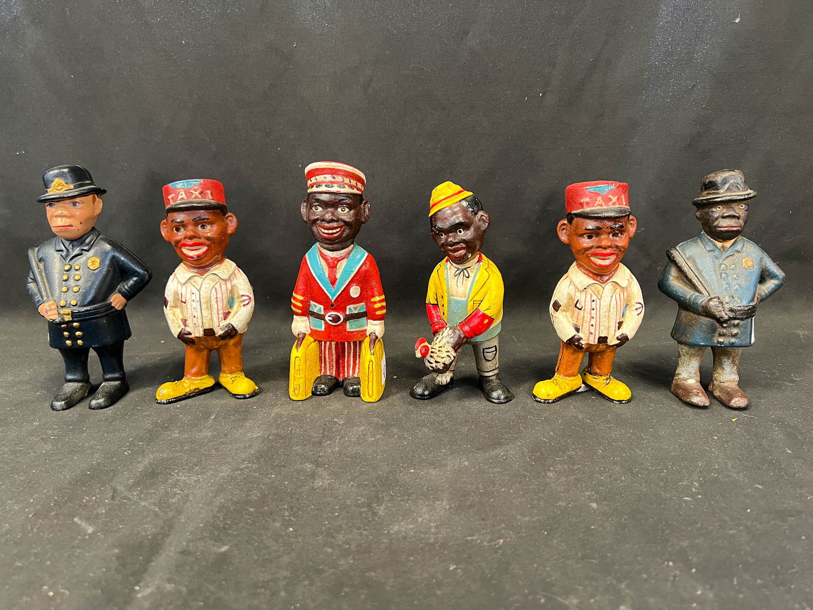 Six contemporary cast iron banks depicting a porter, police man and more (1 of 5)