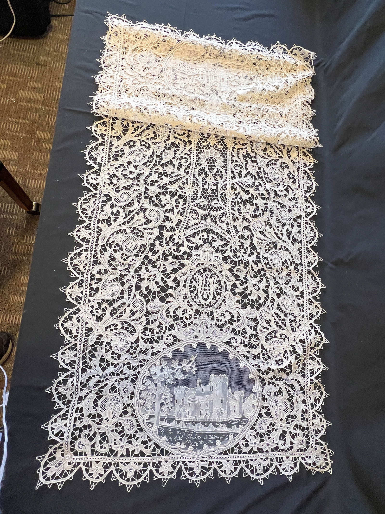 Stunning hand made lace runner and twelve placemats depicting castles and the Uihlein family crest.: Stunning hand made lace runner and twelve placemats depicting castles and the Uihlein family crest. The 12 placemats and runner have several different styles of lace making incorporated in to them. Th