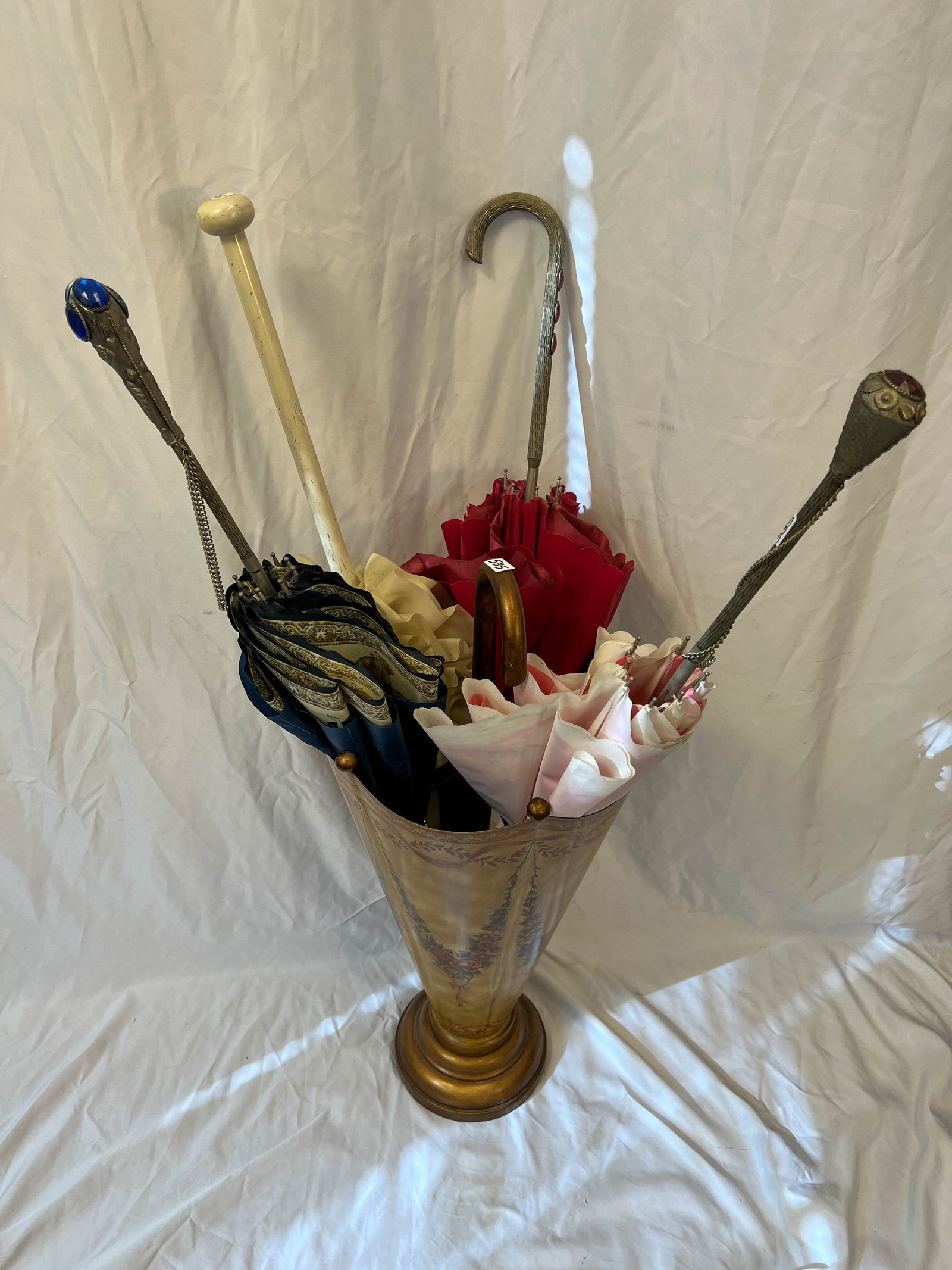 Floral painted Umbrella Holder in the shape of an umbrella: Arose painted umbrella holder in the shape of an umbrella, along with 4 fancy umbrellas