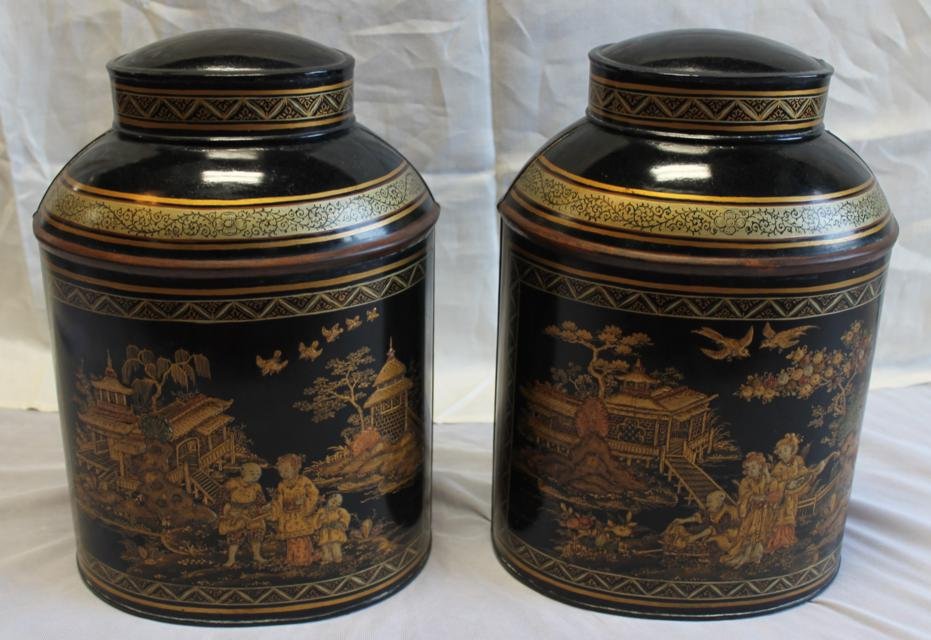Pair of Japanned and lacquered black tin tea canni: Pair of Japanned and lacquered black tin tea cannisters with elaborate oriental decoration. Each measures approx. 14.5" tall by 10" wide.