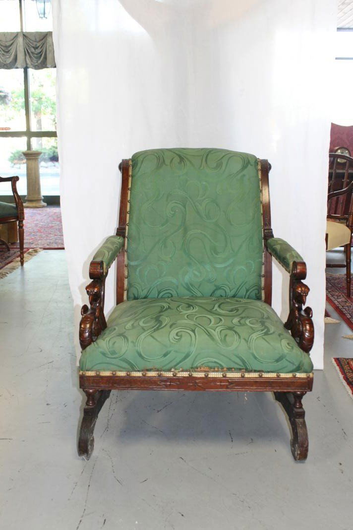 Extra grade Victorian mahogany gentlemen's chair i: Extra grade Victorian mahogany gentlemen's chair in the Eastlake style. Elaborately carved winged griffin armrests. In need of reupholstery.