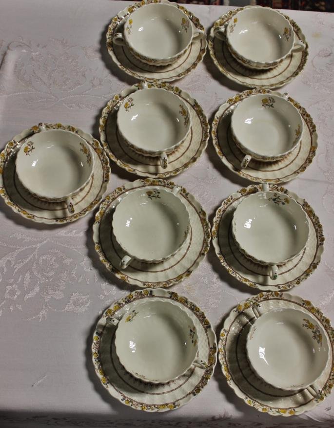 9 Spode Buttercup cream soups & saucers. Soups are: 9 Spode Buttercup cream soups & saucers. Soups are 5” wide & saucers are 7” wide.