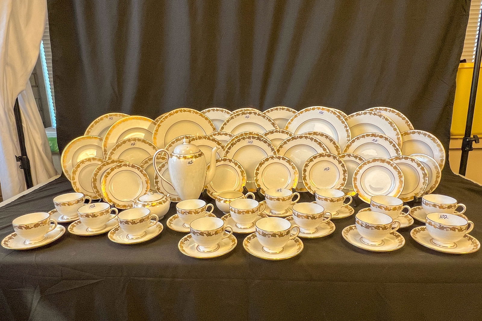 Dinner Service Wedgwood Bone China Made in England: Wedgwood China dinner service with a leaf and berry 24 kt gold border consisting of: coffee pot, creamer, sugar, 12 dinner plates, 12 luncheon plates, 11 dessert plates, and 15 cups and saucers.