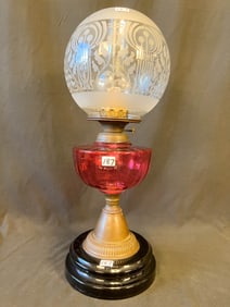 Quality Cranberry Oil Lamp with Frosted Decorative Ball Shade on a Black Lacquer