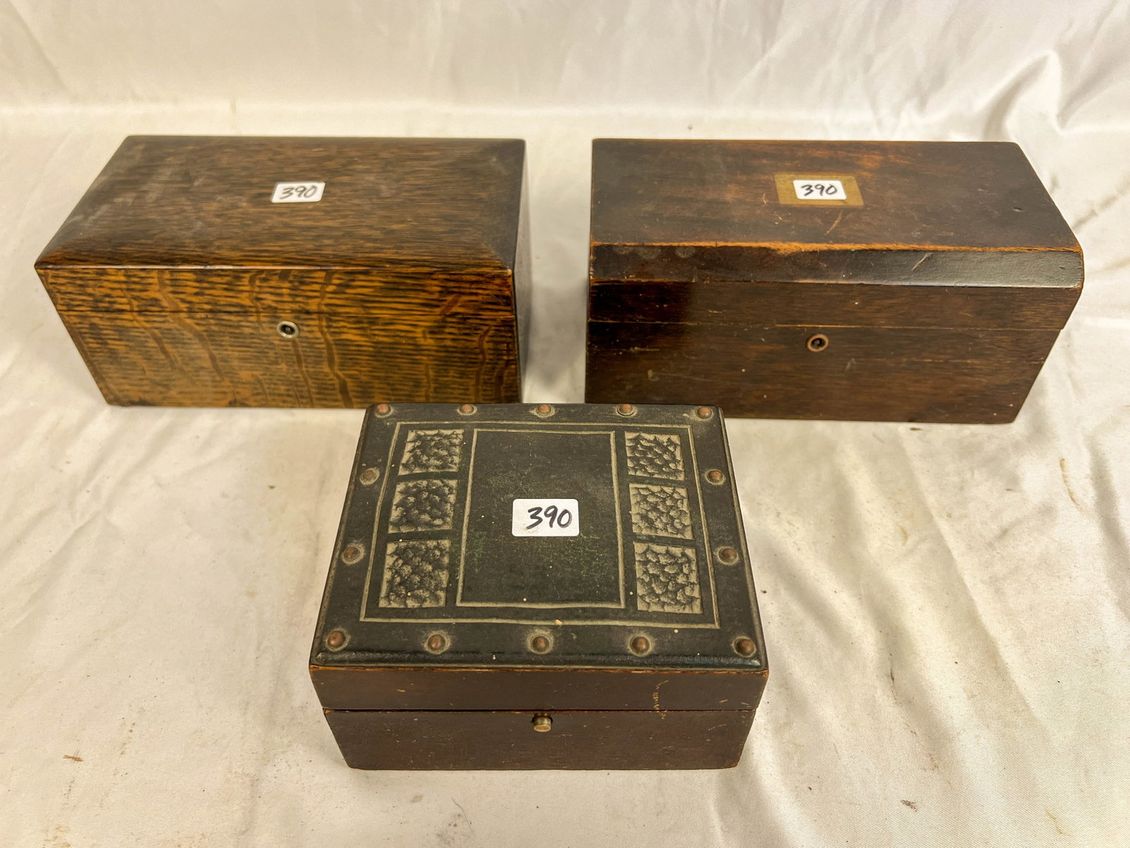 Three Small Porcelain Lined Humidors in Mahogany and Oak: 3 small porcelain lined humidors in (1)mahogany, (1)oak, and (1) with Celtic decorations. All in good condition