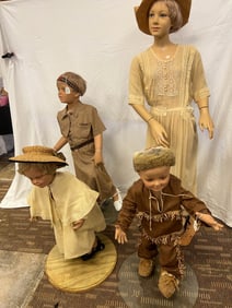 4 children's mannequins on stands, along with an early summer dress,