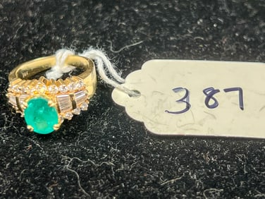 14 K Gold Ring with 10 mm Emerald Center Stone and diamond baguettes and round cut.