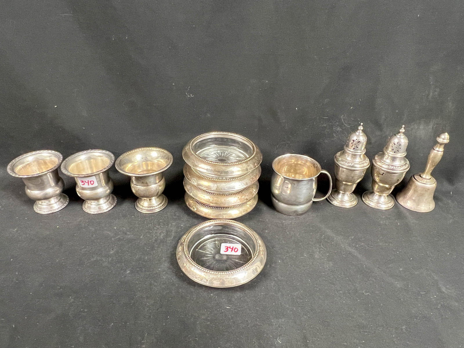 Sterling Lot of Cigarette Holder, Salt, Pepper, Bell and More: Sterling lot of cigarette holder, salt, pepper, bell, baby cup and ashtrays. Weighs 307 grams without ashtrays.