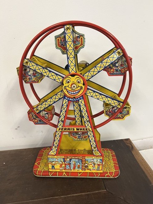 Tin Litho Wind Up Ferris Wheel: Tin litho wind up Ferris wheel. Wheel spins around and a bell rings, this piece features colorful graphics and is in beautiful condition.