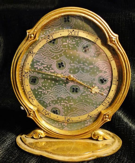 An important French style art deco gold over bronze: An important French style art deco gold over bronze desk clock by Chevron, Swiss, 5-1/4" tall. Est. value $250 - 350.