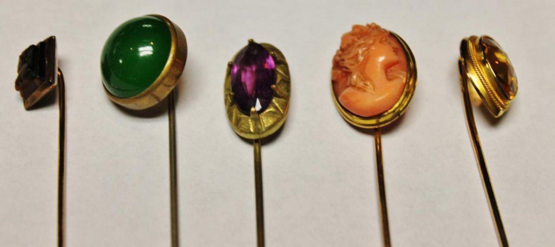 Group of 5 mens' stick pins with an unusual jewelr: Group of 5 mens' stick pins with an unusual jewelry box.to include a pear shaped citrine in gold, a carved pink coral cameo, an amethyst dark green jade & one other. Est. value $250-350