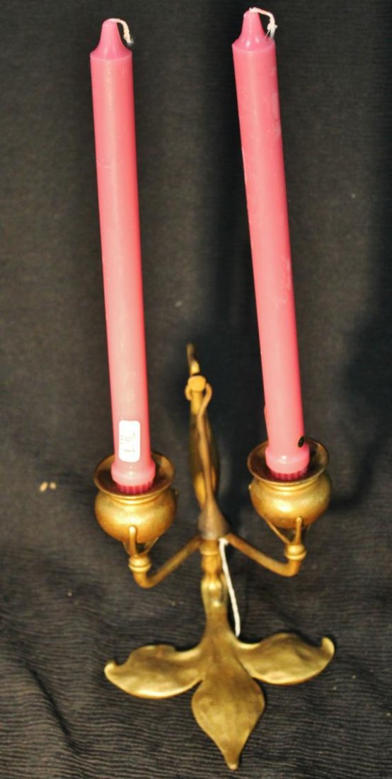 A Tiffany Studios New York #1282 double arm art no: A Tiffany Studios New York #1282 double arm art nouveau candlestick with original candle snuffer and wax catcher, gilt bronze in good condition, measures 9" tall x 7" deep. Out of the Vogel estate on 