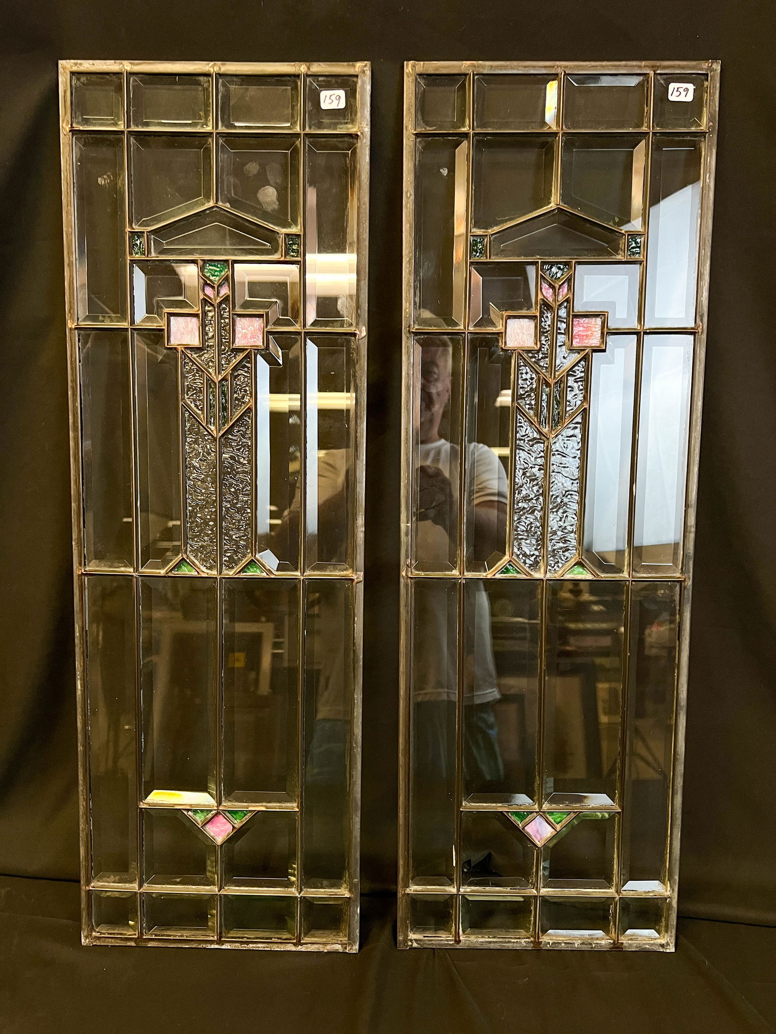 Pair of Arts and Crafts Beveled and Stained Glass Sidelights: A pair of beautiful matching Arts and Crafts sidelight windows. These high quality sidelights feature beveled glass, frosted glass and prairie style design with green and pink glass accents. This outs