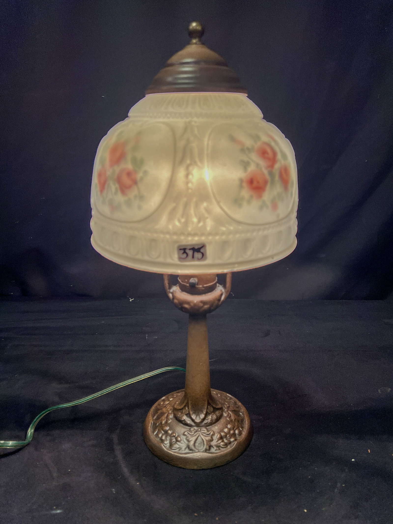 Aladdin Arts and Crafts Boudior lamp C.1930's: This Aladdin painted cast metal lamp has a floral back painted glass shade. In working condition, it measures 14" tall X 8" across.