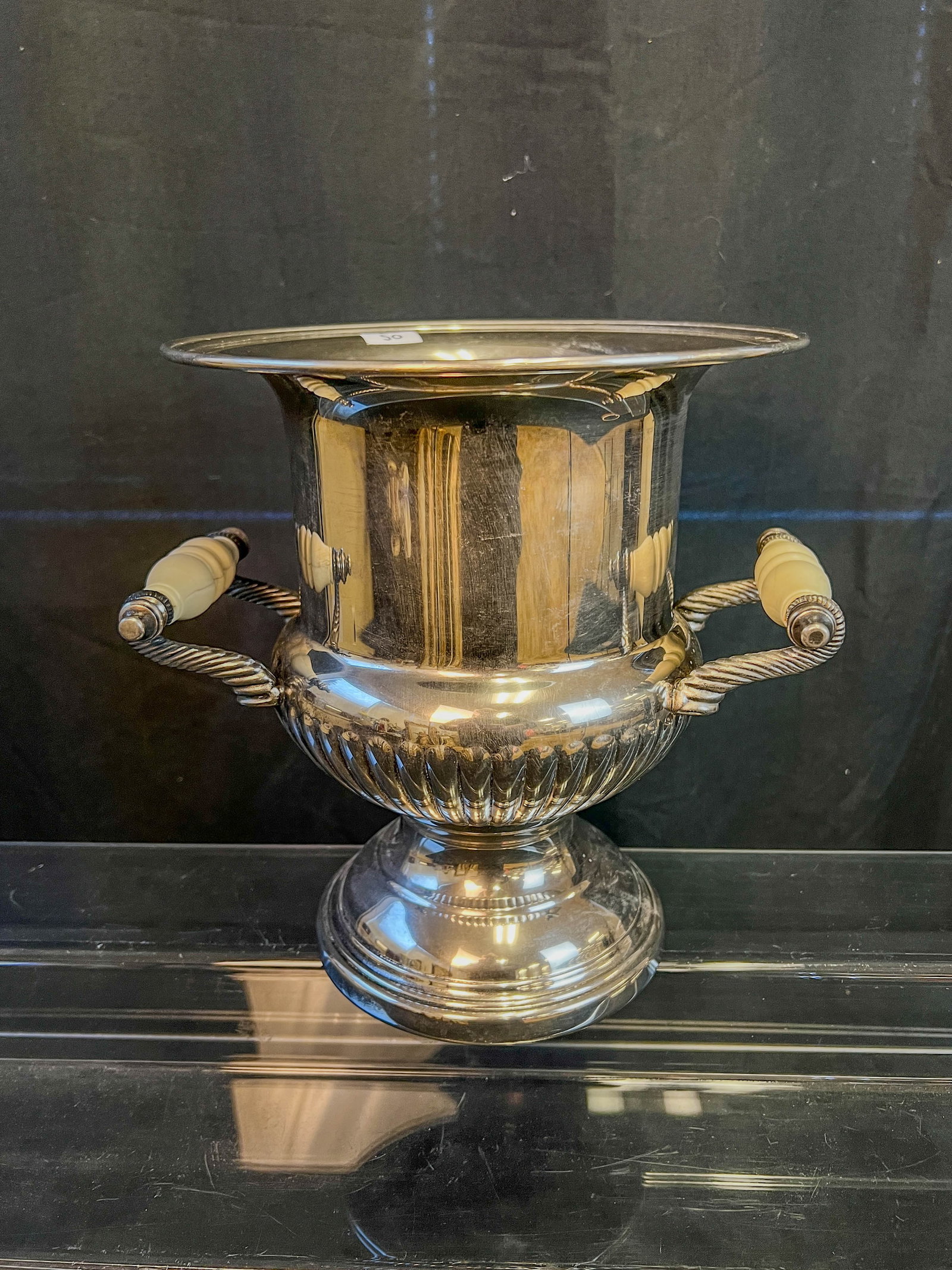 Antique Champagne Bucket with Bone Handles: Antique turn of the century silverplate champagne bucket with bone handles. In excellent antique condition, this piece measures 10" tall X 10" across.