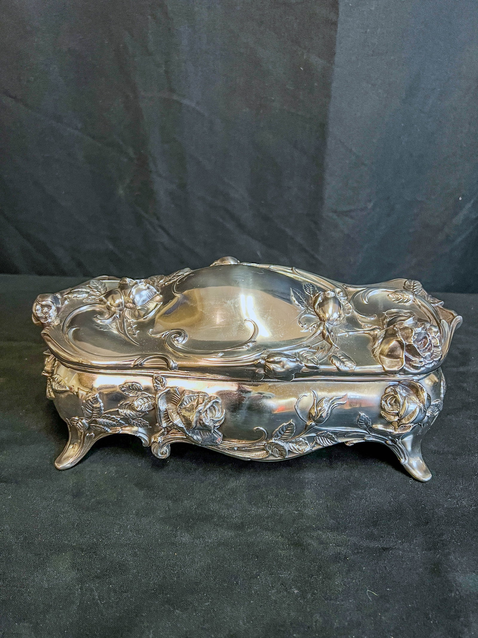 Silverplate Floral Jewelry Casket: An elaborate restored Edwardian jewelry casket in silverplate with mohair lining. Piece features floral design with roses and is marked "W.B. MFG Co." on bottom. Measures 4.5" tall X 11" across X 4.25