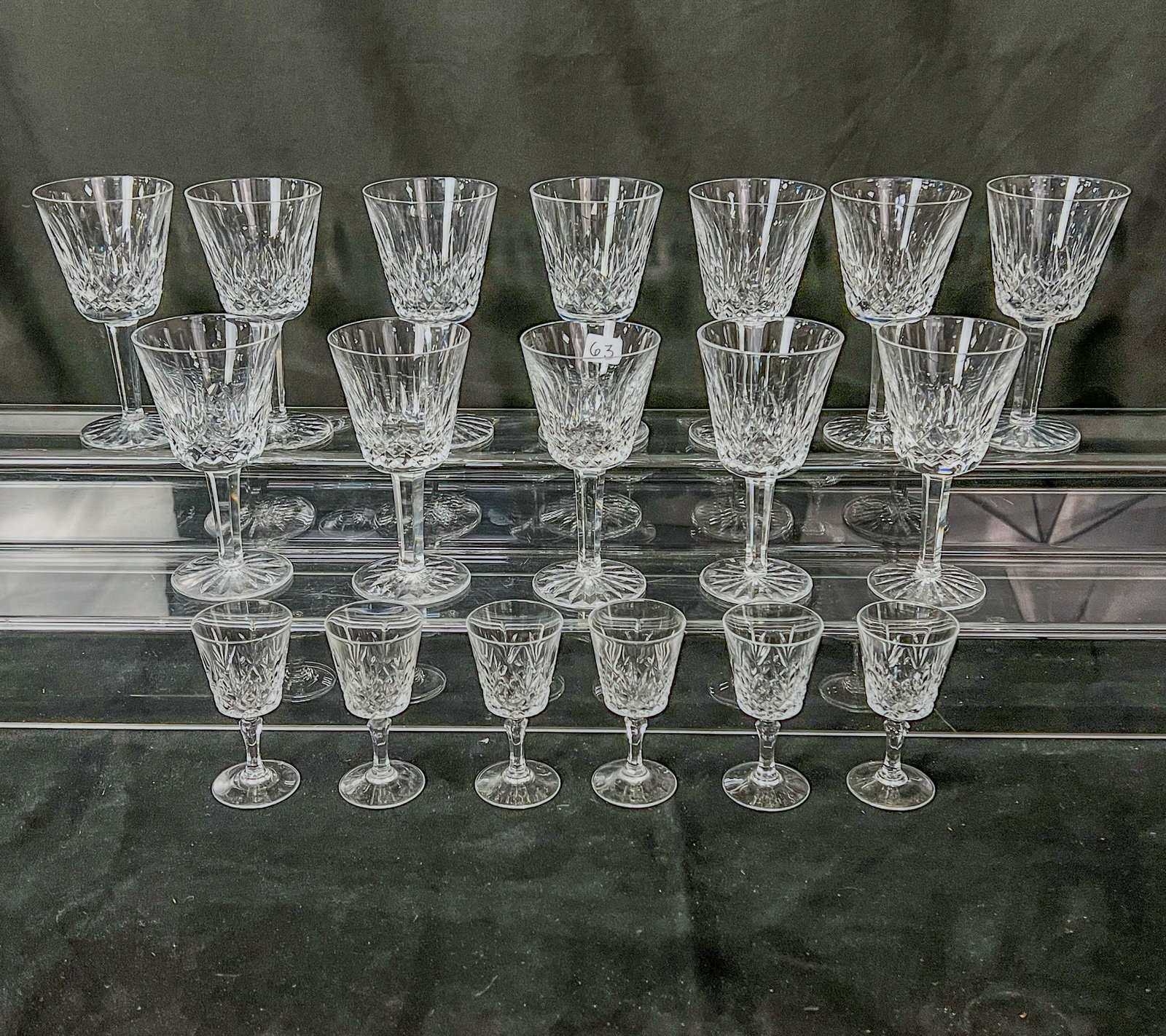 Waterford Lismore Crystal Stemware: A set of 12 wine goblets and 6 cordials in the Lismore pattern by Waterford. Goblets measure 6" tall, cordials measure 4" tall. Goblets are marked Waterford on bottom of base.