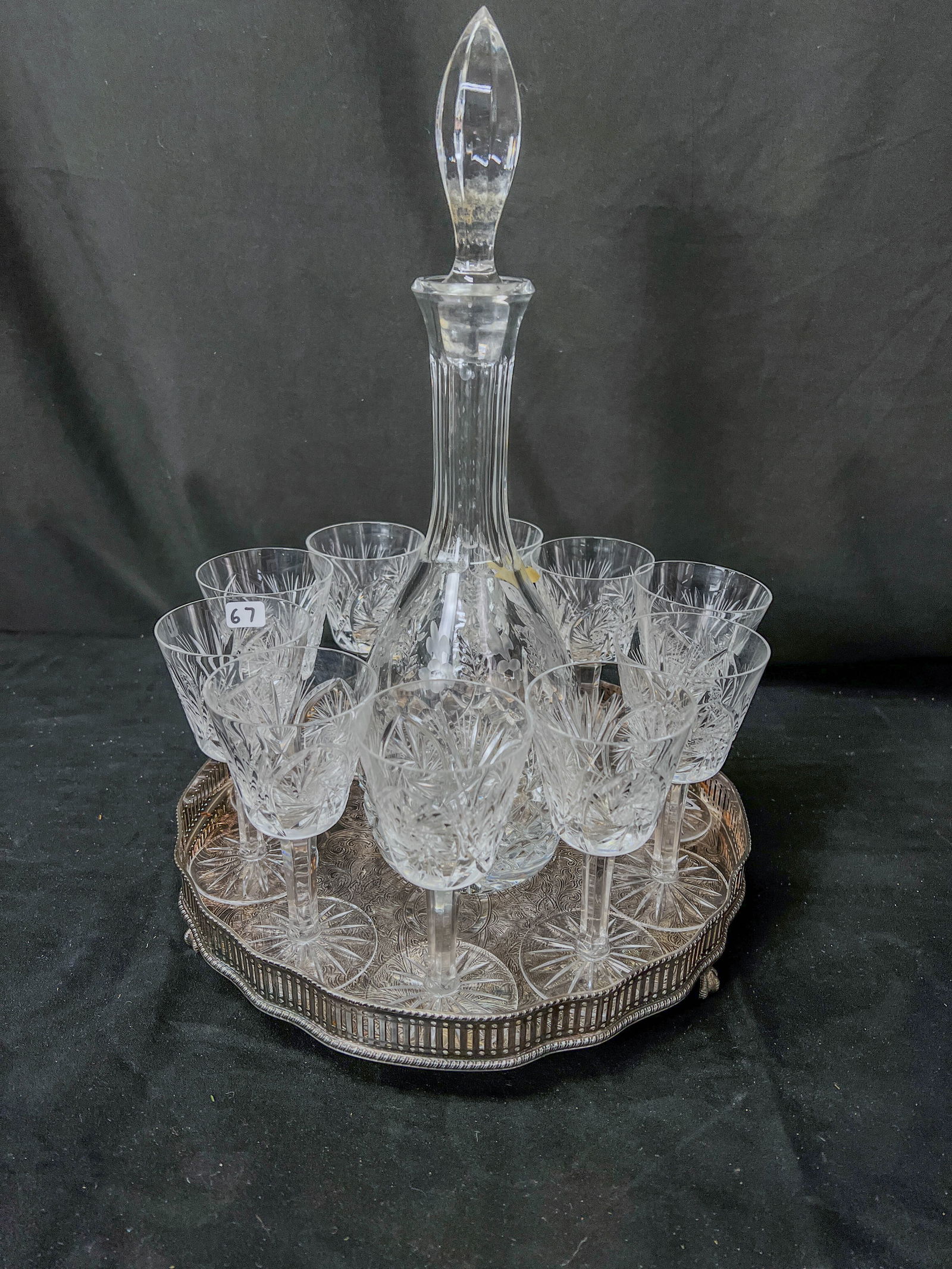 10 Cut Crystal Goblets, Decanter. and Reticulated Silverplate Tray: A set of 10 wheel cut crystal goblets along with a Tuscany floral etched 16" crystal decanter and a Reed and Barton reticulated edge silverplate tray. Tray has elaborate chasing and measures 2.25" tal