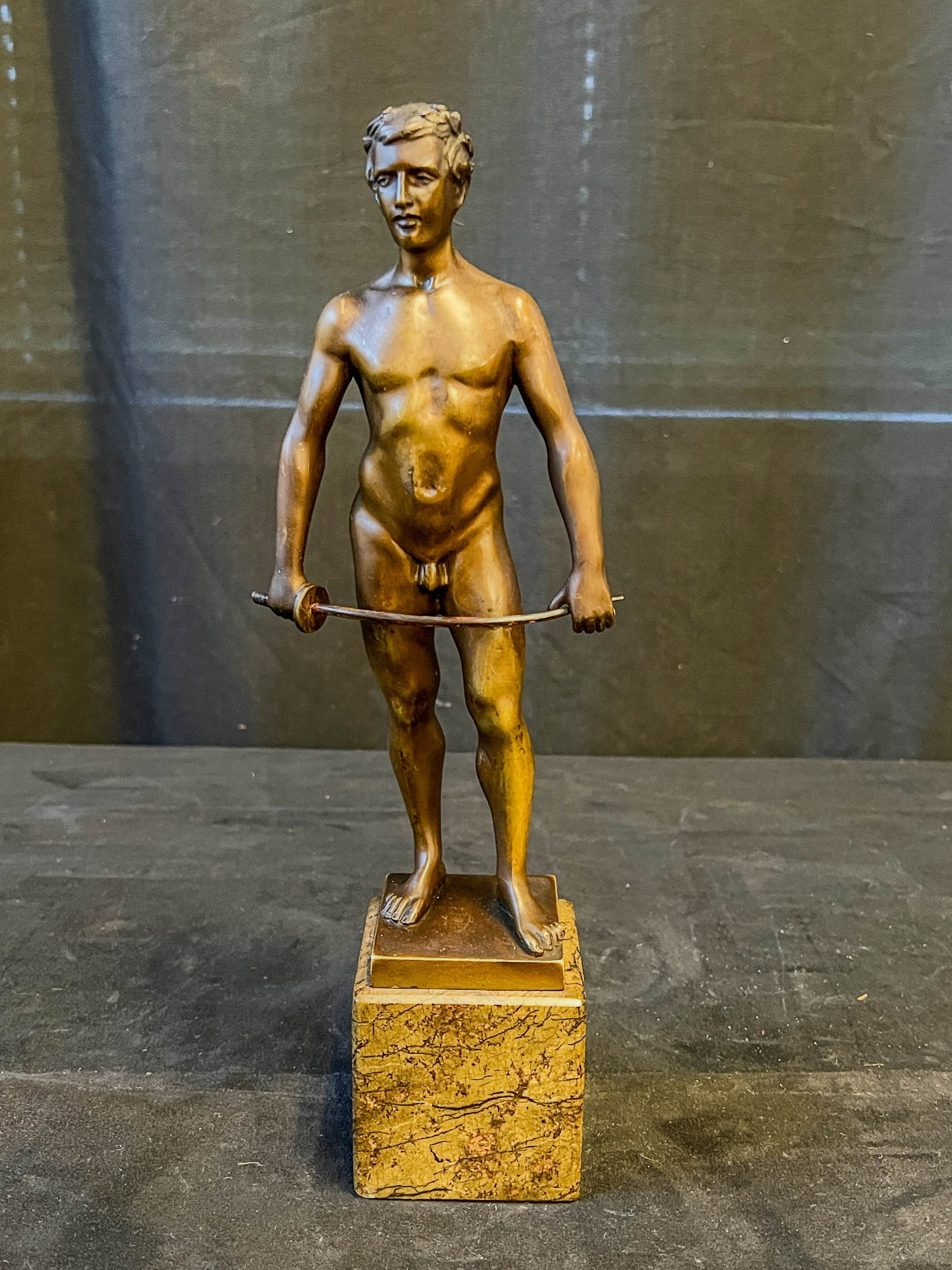 Spiro Schwatenberg Bronze Fencer Statue c. 1900: This bronze male figurine depicting a nude fencer wearing a wreath of laurel leaves on marble plinth is by listed German Artist Spiro Schwatenberg (1898-1922). It is signed on the back of the statue a