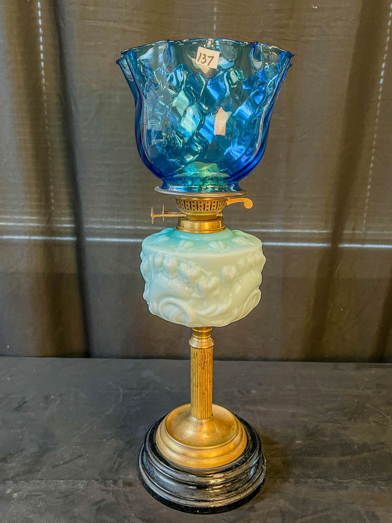 English Blue Case Glass Duplex Burner Oil Lamp: An English duplex burner oil lamp with a blue case glass font depicting bleeding heart flowers. Shade is a French blue swirl shade, lamp does not come with a chimney. Lamp measures 22" tall without ch