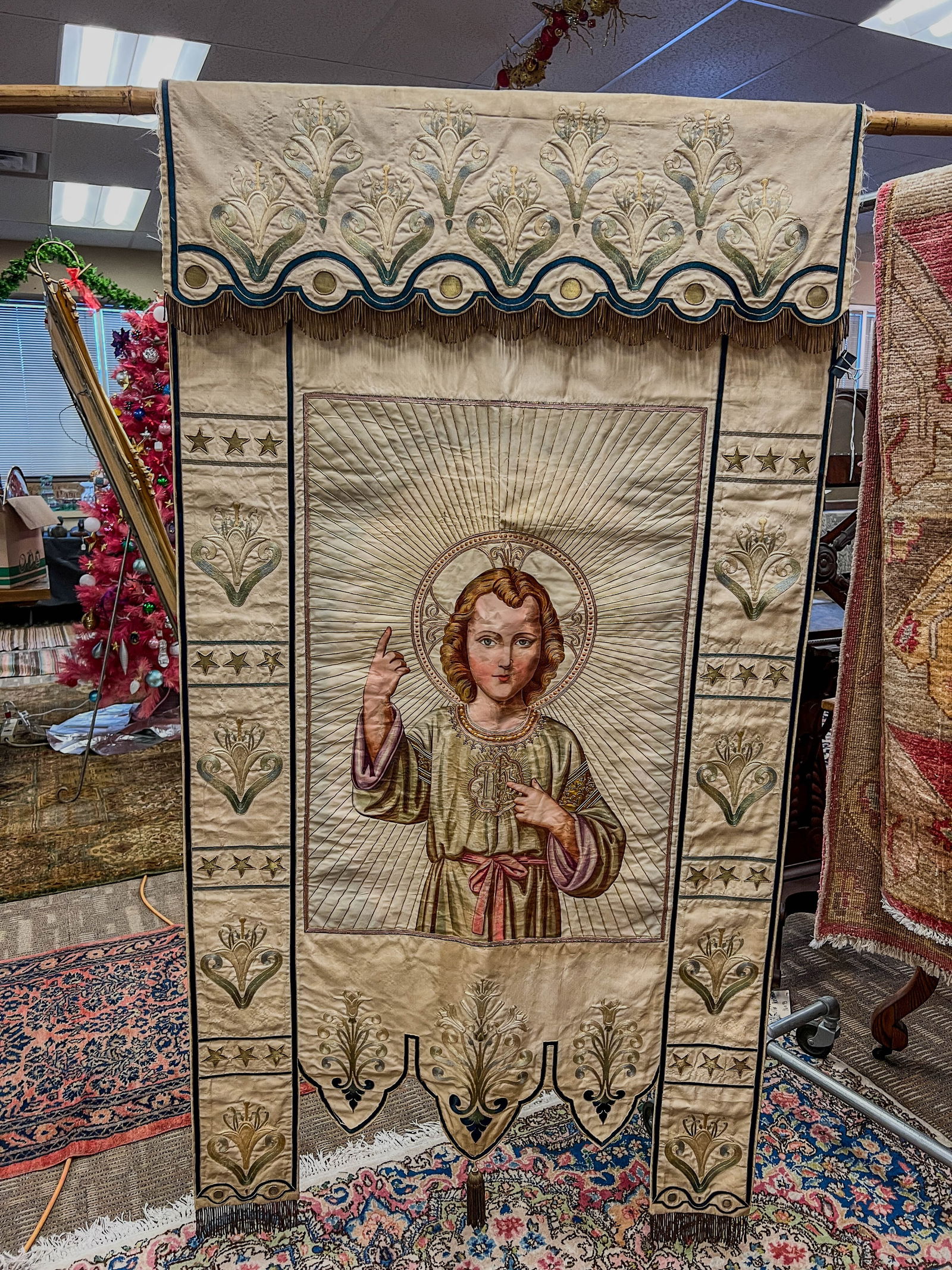1890's Liturgical Banner of Jesus Mt. Calvary Wisconsin: A very high quality large Liturgical banner with a well hand painted baby Jesus, gold metal threadwork, elaborate embroidery and metal wire fringe. This piece is very well made and dates to the 1890s.