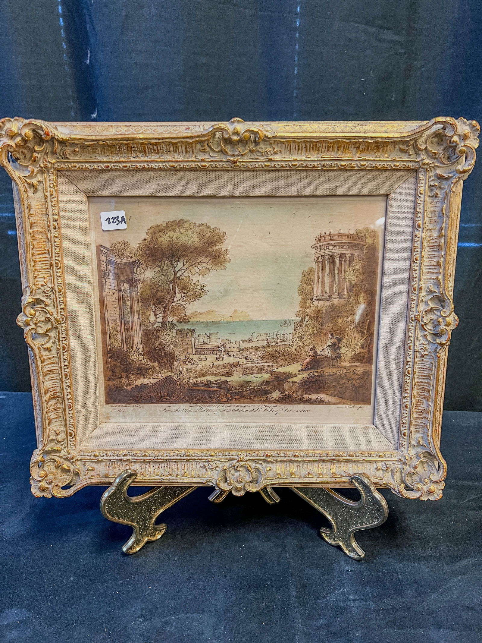 John Boydell English Hand Colored Engraving C. 1776: A John Boydell English hand colored engraving in quality frame. Engraving comes from a drawing in the collection of The Duke of Devonshire. Framed, this piece measures 13" tall X 15" across.