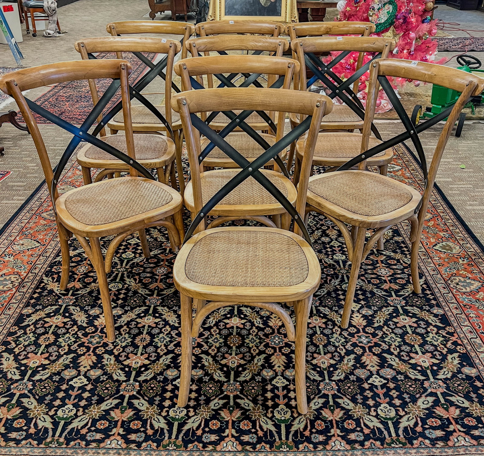 Set of 10 Bentwood and Iron Dining Chairs: A set of 10 bentwood and iron dining chairs in oak with woven seat. These designer chairs measure 35" tall X 17" across X 16.5" deep.