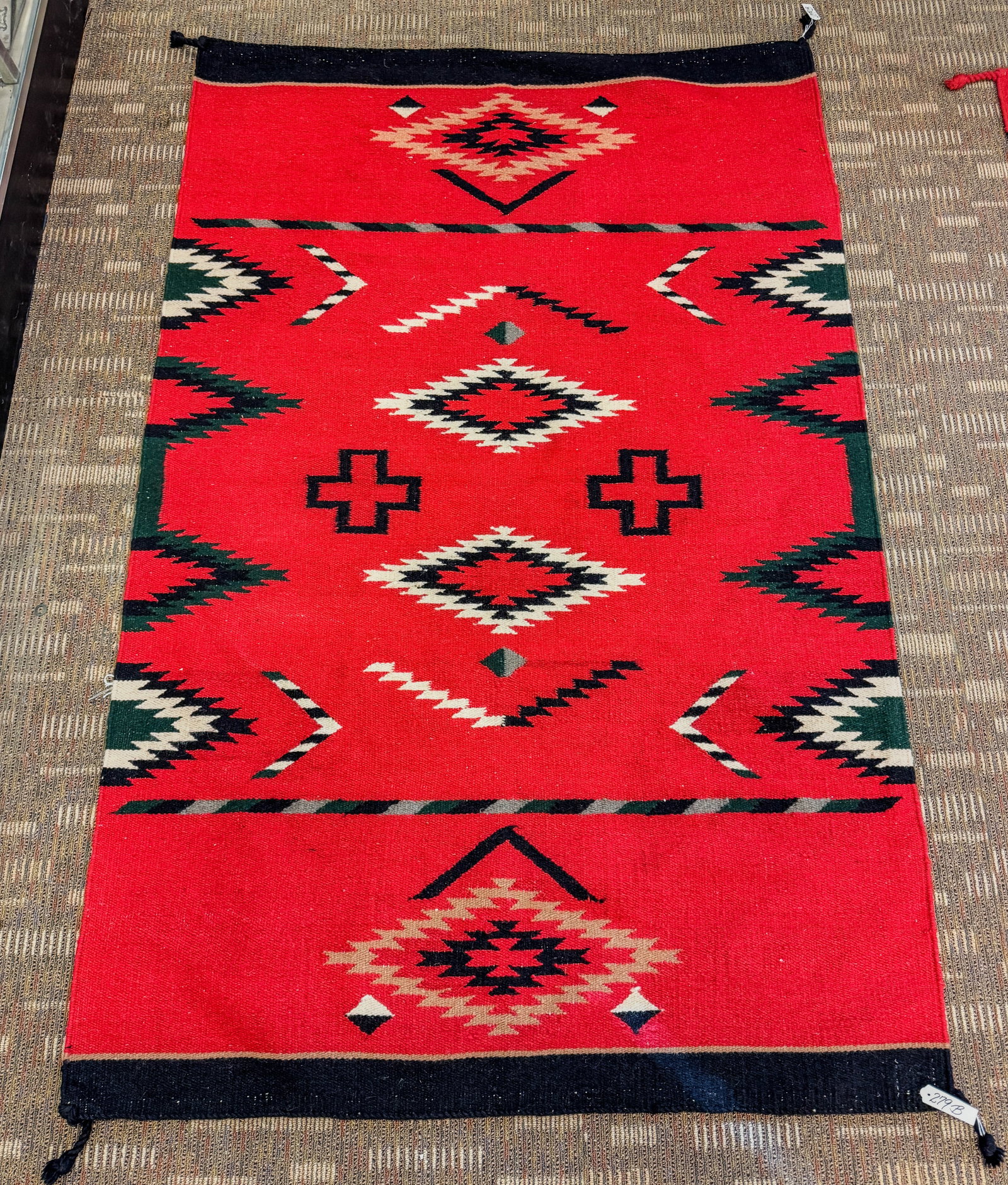 Southwest Hand Woven Indian Rug: A Southwest handwoven Indian horse blanket with red centerfield and black borders. Appears to have some age. Rug measures 72" X 47".