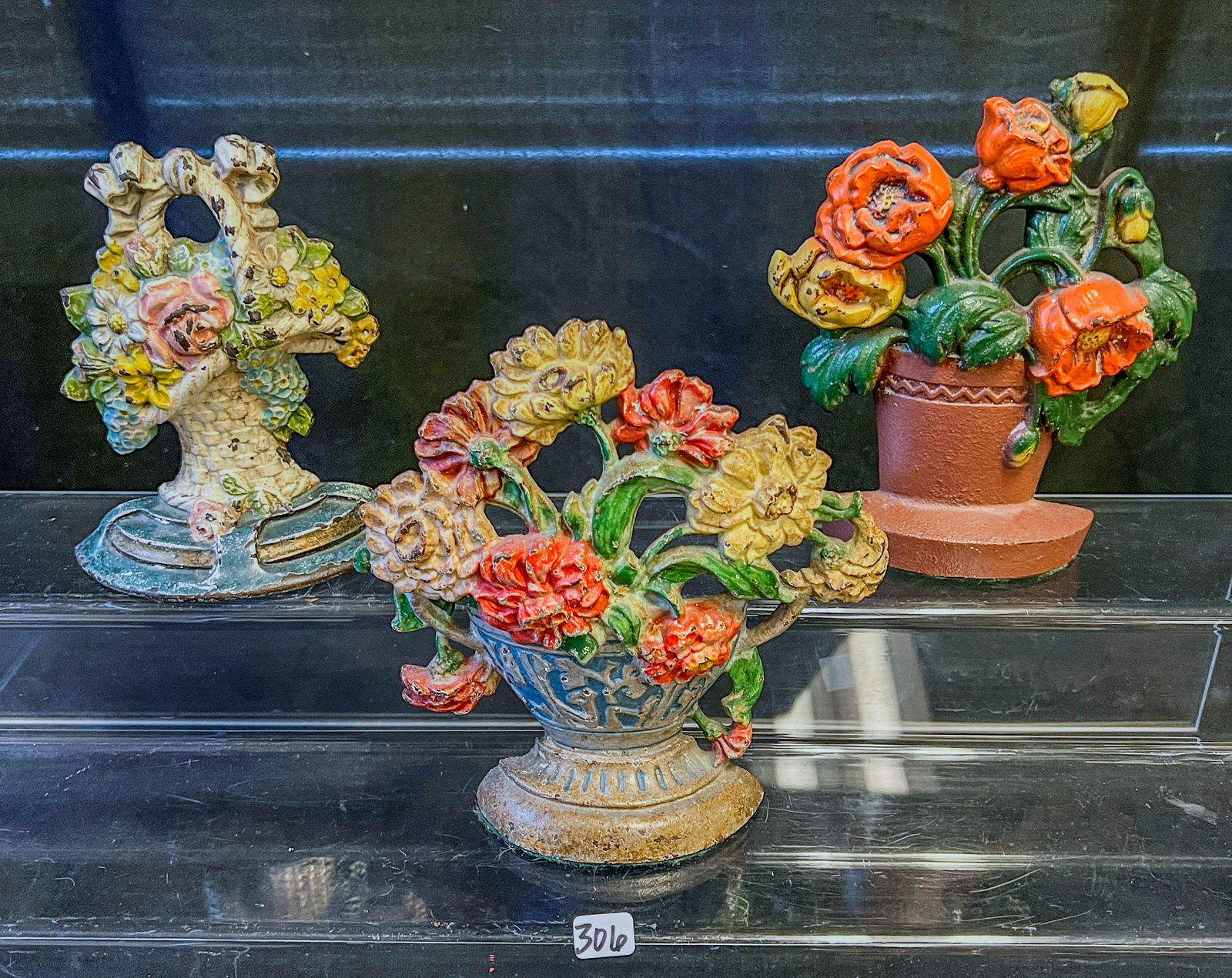 3 Cast Iron Floral Bouquet Doorstops: A group of 3 cast iron Floral bouquet door stops with original paint in good condition. they measure 6.5" to 7" tall.