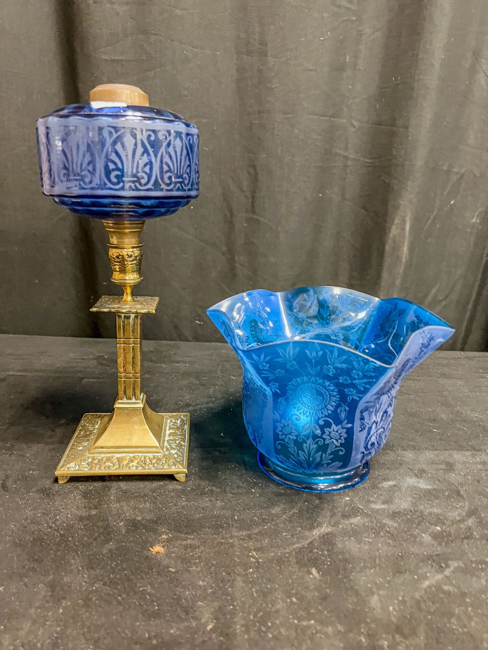 Blue Acid Cutback Oil Font, Shade and Bronze Candlestick: blue acid cutback peg font, a fancy bronze candlestick base and a stunning blue floral acid cutback shade measuring 5" X 8. Lamp needs a burner to be complete.