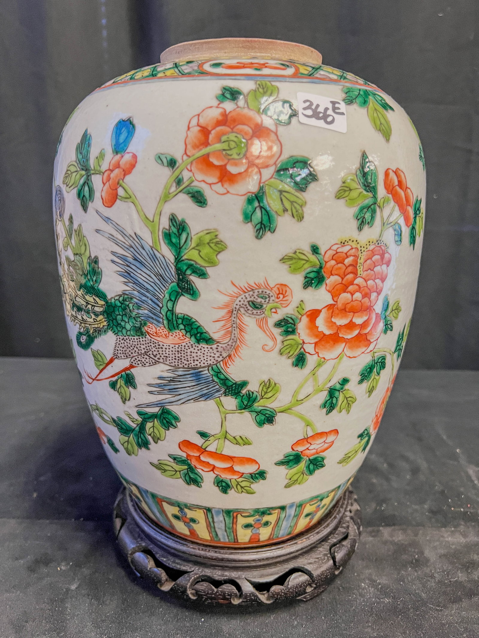 18th Century Chinese Porcelain Ginger Jar: This wonderful 18th century Chinese porcelain ginger jar has a whimsical peacock flying on a field of flowers. This would have originally had a wood top. Also included is a carved ebonized stand. In e