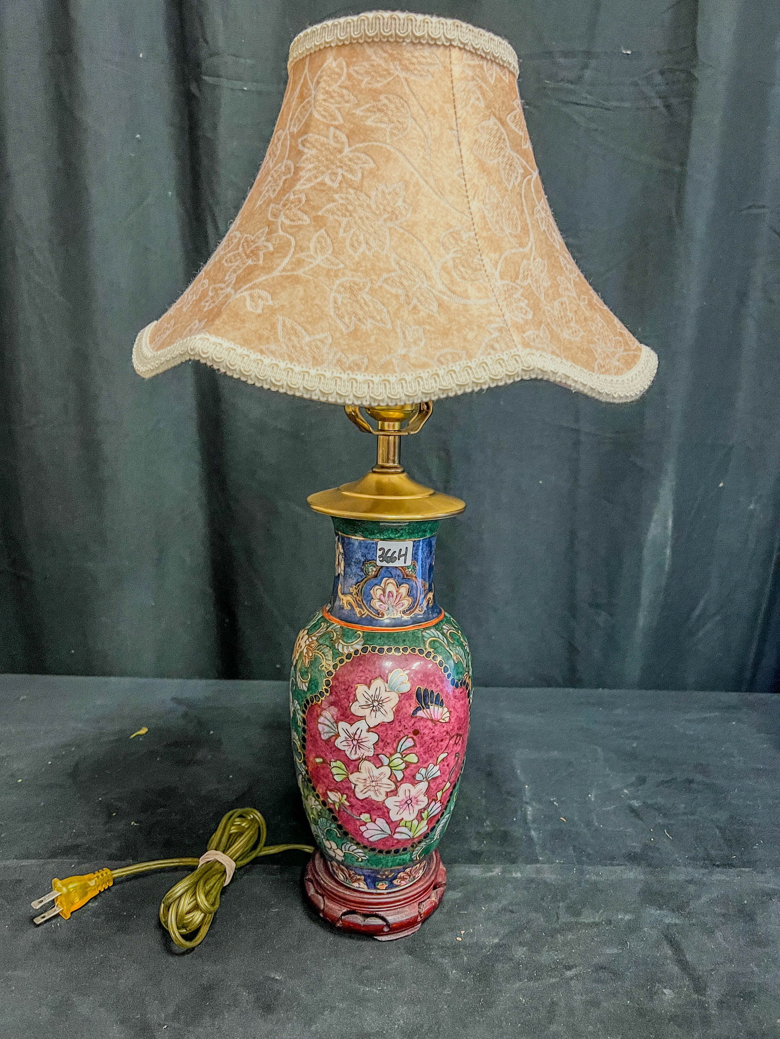 Porcelain Hand Painted Chinese Lamp: This hand painted porcelain Chinese lamp features flowers and butterflies, along with a silk pagoda shaped shade. In excellent condition, it measures 21" tall X 5" across.