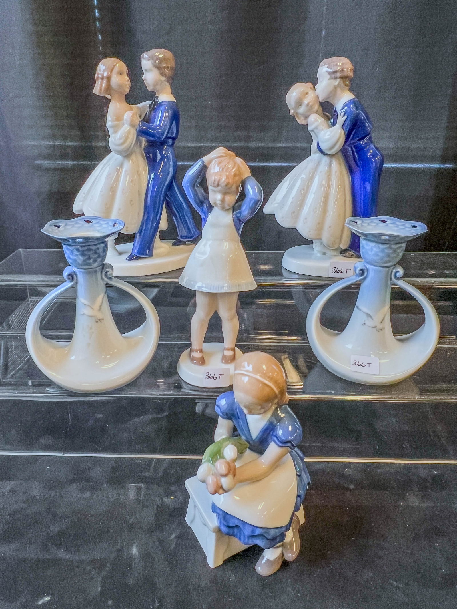 Group of Bing and Grondahl Figurines, Candlesticks: This group oof Bing and Grondahl Danish porcelain figurines includes Youthful Boldness/Kissing #2162 (8" T), Dancing Couple #2385 (8" T), Anne#2381 (7.5" t), and Ida's Flower 32298 (6" tall). Also inc