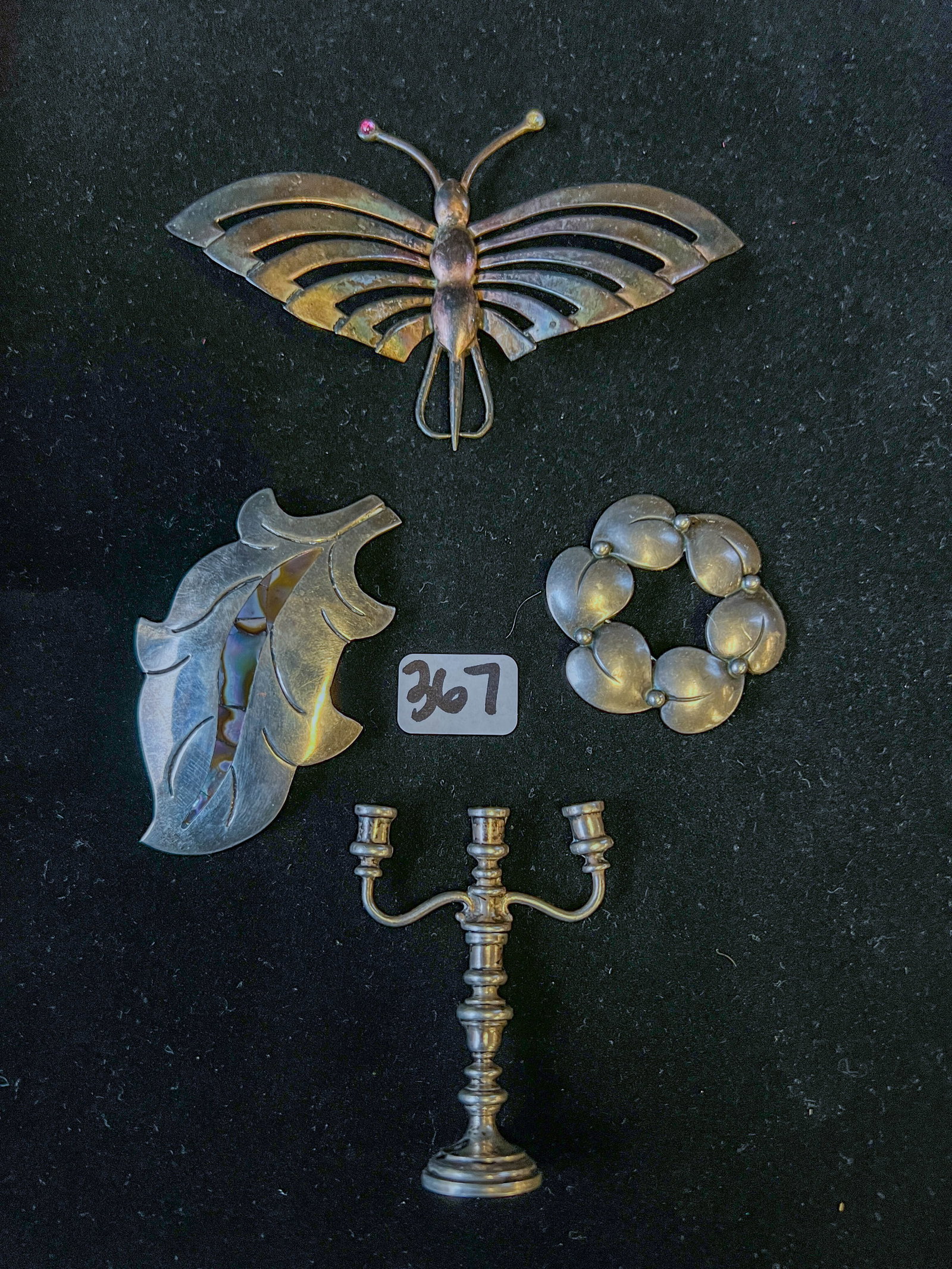 Lot of 4 Sterling Pieces: A lot of 4 sterling pieces to include a large butterfly pin, a wreath pin, a leaf pin, and a miniature candelabra. The weight of the sterling together is 55.2 g.