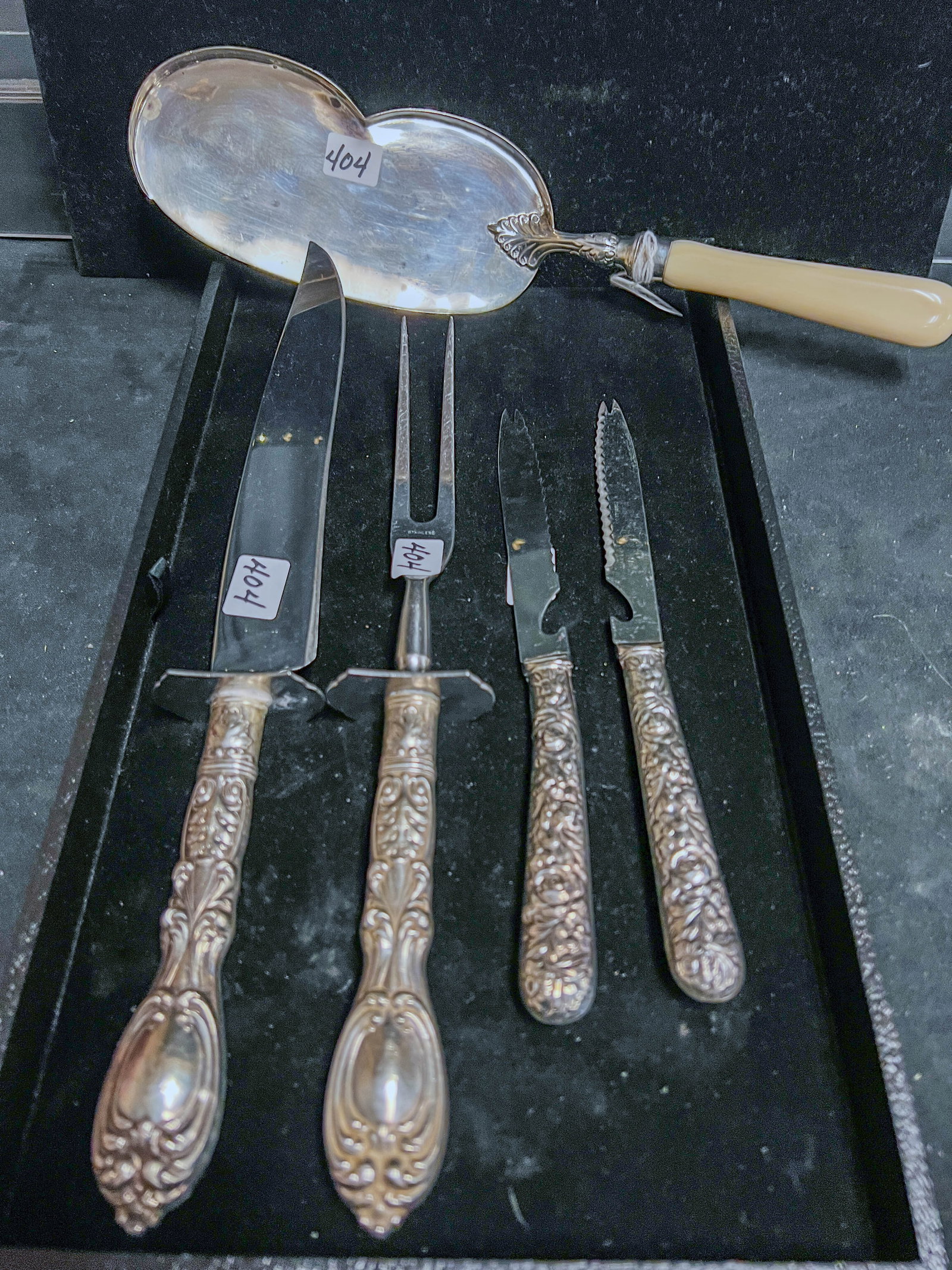 Group of Victorian Sterling Serving Ware: A group of assorted Victorian serving ware. Group includes weighted handle sterling serving knife and fork, 2 Wavecrest smaller weighted sterling handle knives, and a sterling with bone handle crumb s