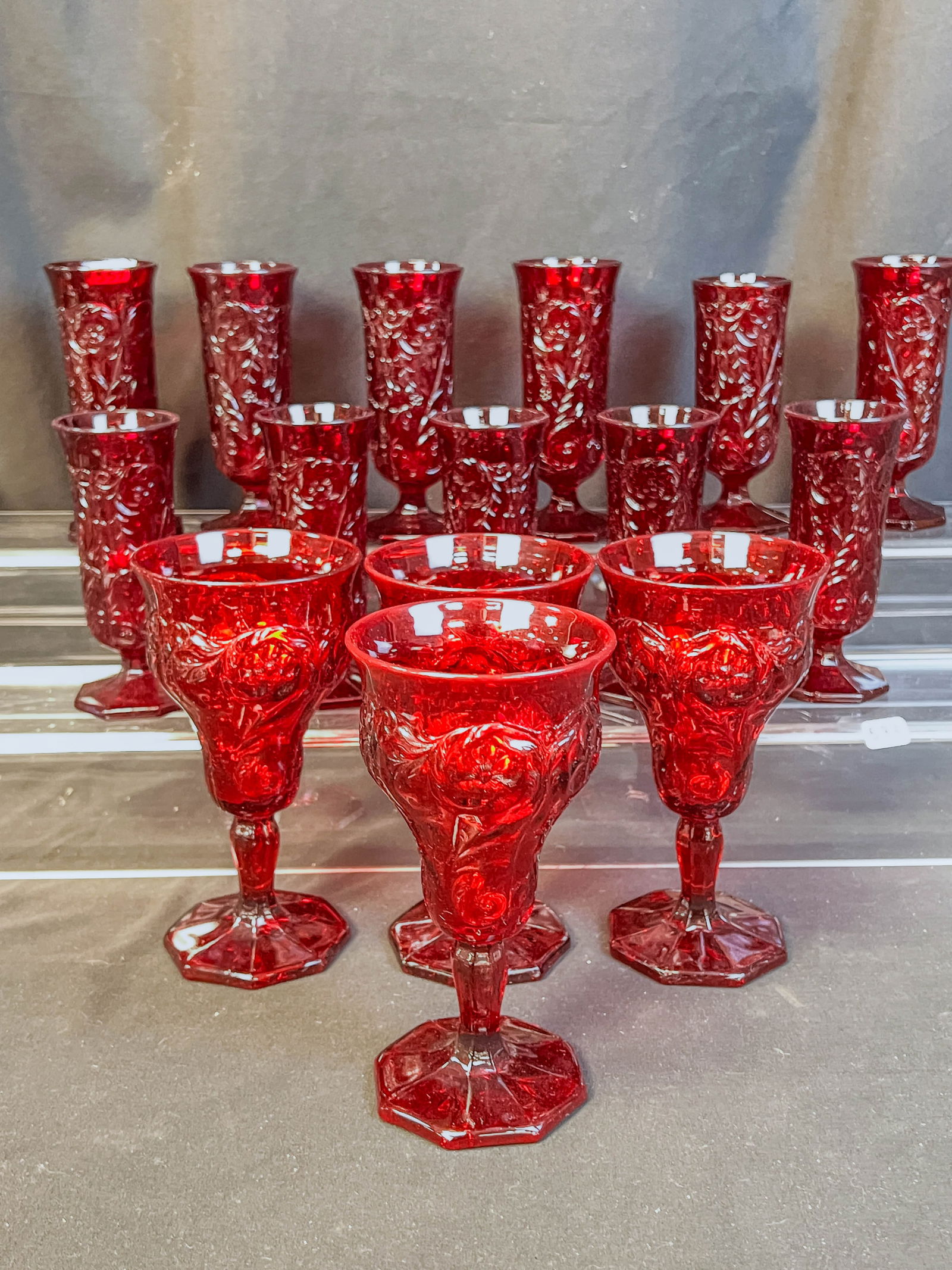 McKee Glass "Rock Crystal" Cordials, Goblets: This group of mid-century McKee Glass Rock Crystal glasses include eleven 5" tall Cordials in ruby and four- 6" tall ruby goblets.