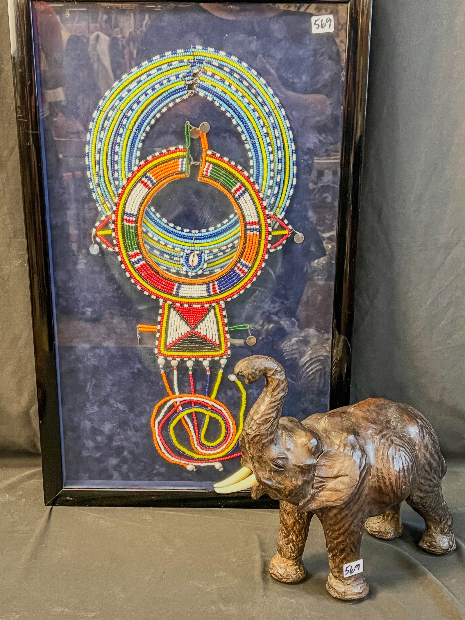 African Masai Beaded Necklaces, Leather Elephant: This group of African handmade beaded necklaces in a shadow box frame are from the Masai Tribe of Kenya. Shadowbox frame measures 24" tall X 15" across. Also included is a leather hide elephant figure