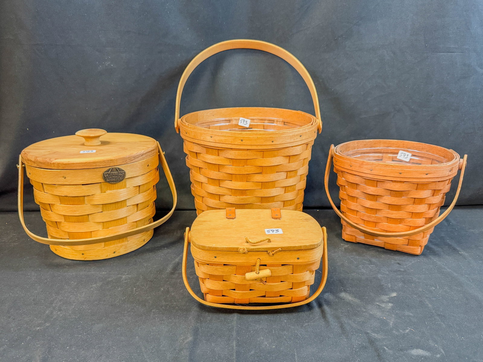 4 Longenberger Baskets: 4 Longenberger Baskets with handles, liners, 2 with lids.