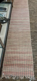 A long handwoven rag rug runner