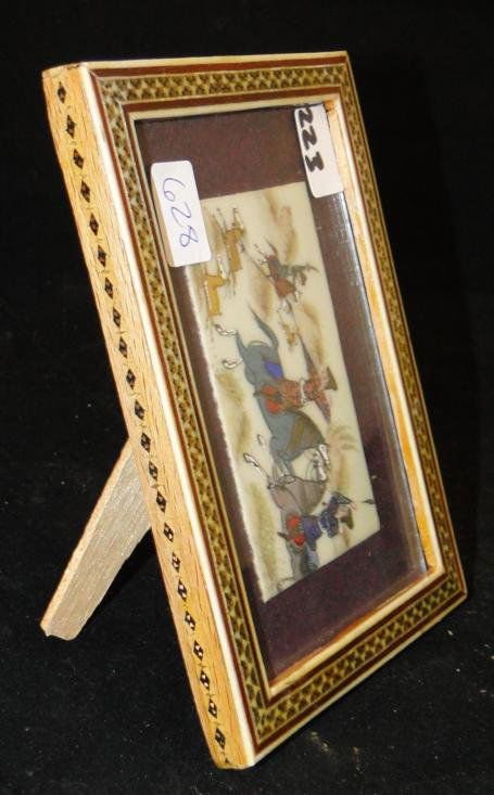 Framed ivory plaque w/ oriental hunting scenes. Est. va: Framed ivory plaque w/ oriental hunting scenes. Est. value $100-125
