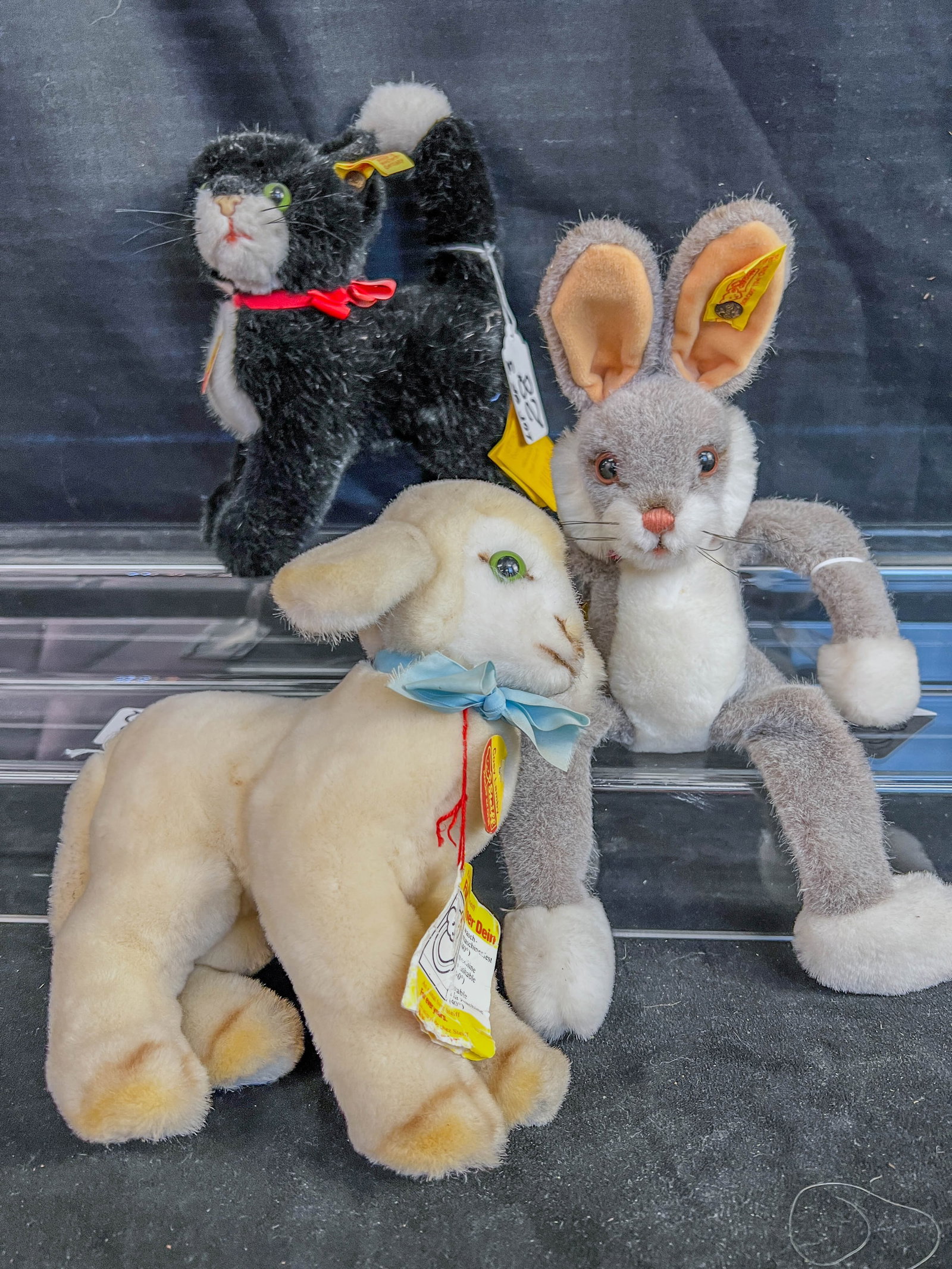 3 Steiff Animals to include Tuxedo Cat, Lamb, and Rabbit: 3 Vintage Steiff plushy animals to include a stgeirff bunny with earbutton and tag and paper lavbel (12" tall), Dossy the tuxedo cat with brass ear button and tag, and original paPWER LABELS (8.5" TAL