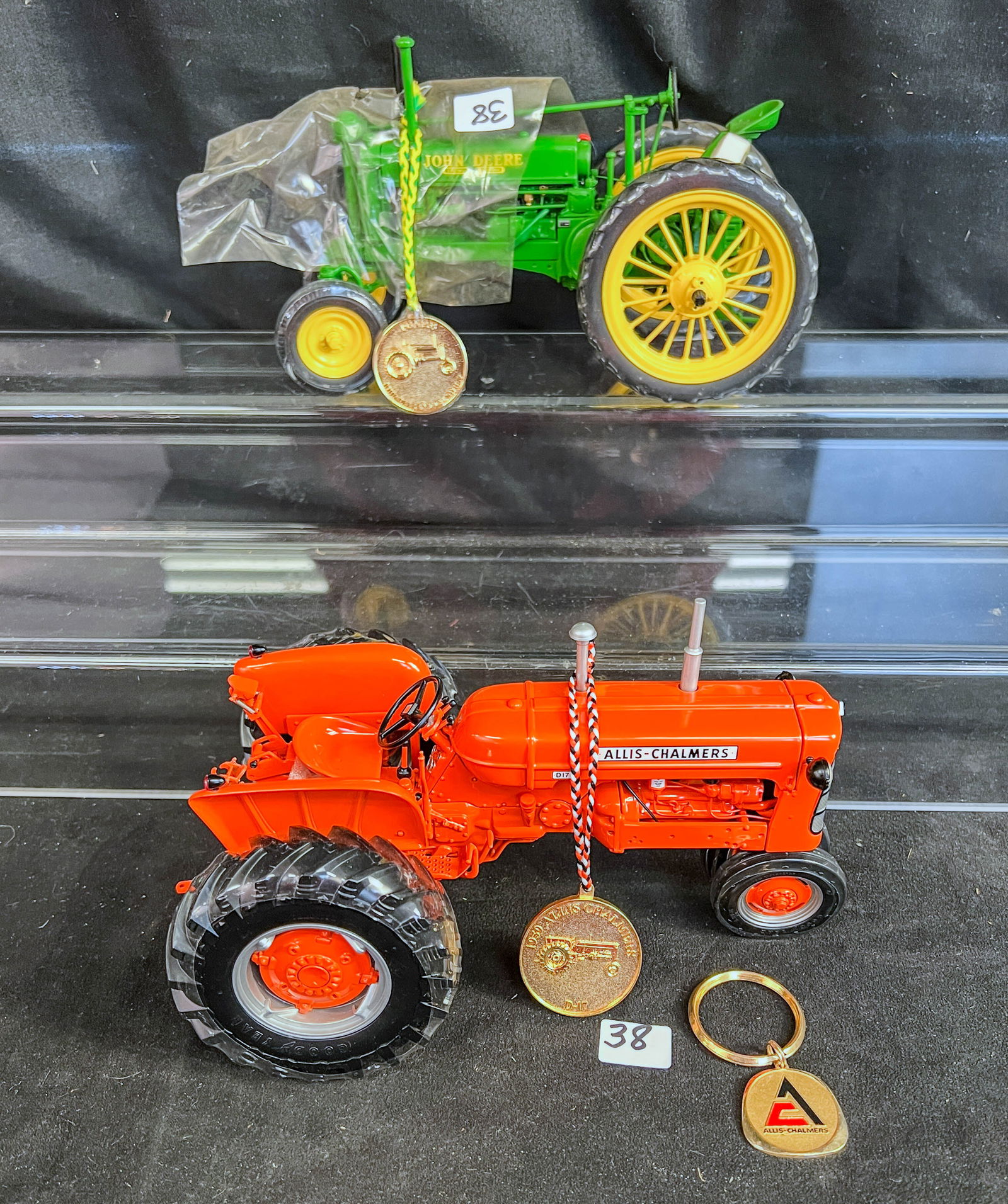 2 Erlt 1/16 Scale Die Cast Precison 11 Series Tractors, Allis Chalmers D-17 , and John Deere General: 2 Ertl metal die cast 1/16 scale Precision Series tractors with thier gold coins and shrink wrapped wheels to include an orange Allis Chalmers D-17 tractor with front axle motion, and a green John Dee